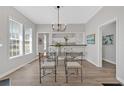 Bright dining area featuring a modern chandelier and an open layout to the kitchen at 345 Wellington Sw St, Atlanta, GA 30310