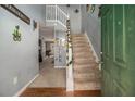 Bright foyer with wood flooring and a staircase with white railing at 5636 One Lake Way, College Park, GA 30349