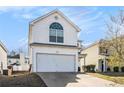 Two-story house with garage, showing simple landscaping and sunny skies at 5636 One Way, College Park, GA 30349