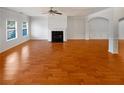 Spacious living room featuring a fireplace, gleaming hardwood floors, and abundant natural light at 755 Autumn Blfs, Fairburn, GA 30213