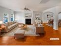 Bright living room features a fireplace, hardwood floors, and dining area access at 755 Autumn Blfs, Fairburn, GA 30213