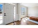 Inviting entryway with hardwood floors and natural light from sidelight window at 4048 Sandy Branch Ne Dr, Buford, GA 30519