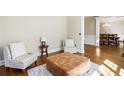 Cozy seating area with wood floors, neutral walls, and decorative throw pillows at 4048 Sandy Branch Ne Dr, Buford, GA 30519