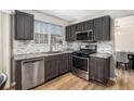 Modern kitchen with stainless steel appliances, gray cabinets, granite countertops and hardwood floors at 4283 Brighton Nw Way, Kennesaw, GA 30144