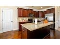 Modern kitchen featuring granite countertops, stainless steel appliances, and dark wood cabinetry at 2401 Day Break Way, Dacula, GA 30019