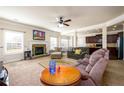 Spacious living room with a fireplace, carpeted floors, and ample natural light at 2401 Day Break Way, Dacula, GA 30019