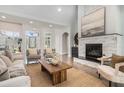 Bright living room featuring hardwood floors, a stone fireplace, a neutral color palette, and ample natural light at 5690 Rutland Trce, Lithonia, GA 30058