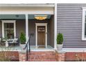 Charming covered front porch with brick steps, quaint decor and front door at 629 Hansell Se St, Atlanta, GA 30312