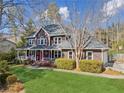 Beautiful two-story home with well-manicured lawn, bright red door and inviting front porch at 703 Somerset Dr, Lawrenceville, GA 30046