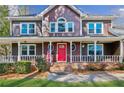 Charming two-story home with a welcoming front porch, well-maintained lawn and a red front door at 703 Somerset Dr, Lawrenceville, GA 30046