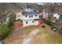 Aerial view of the home showing the backyard deck and surrounding mature trees at 2370 Mcafee Rd, Decatur, GA 30032