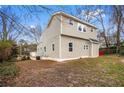 A two-story home featuring vinyl siding and a backyard on a lot with mature trees at 2370 Mcafee Rd, Decatur, GA 30032