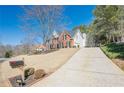 Charming two-story brick home with a long driveway and well-maintained landscaping at 4780 Woodruff Trce, Cumming, GA 30028