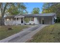 Charming brick home with long drive, painted white with black trim at 1066 Cleavemark Dr, Clarkston, GA 30021