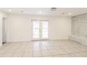 Bright living room with tile floors and French doors, perfect for entertaining guests at 2330 Lago Dr, Jonesboro, GA 30236