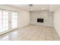 Spacious living area with tile floors, fireplace, and french doors for natural light at 2330 Lago Dr, Jonesboro, GA 30236