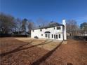 Expansive backyard showcasing a well-maintained lawn and a classic white-painted exterior at 2716 Wynford Sw Ave, Marietta, GA 30064