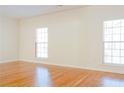 Spacious bedroom with hardwood floors and two windows providing natural light at 5352 Beaver Br, Norcross, GA 30071