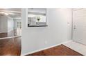 Light-filled entryway with hardwood floors, mirrored wall, and a view of the kitchen at 1510 Gettysburg Pl, Atlanta, GA 30350