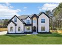 Beautiful two-story home with a well-manicured lawn, black trim, and modern design at 3057 Bold Springs Rd, Dacula, GA 30019