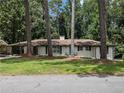 Charming single-story home with a well-maintained lawn, stone walkway, and a bright blue front door at 546 Milligan Dr, Stone Mountain, GA 30083