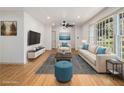 Bright living room featuring hardwood floors, a large picture window, and modern furniture at 546 Milligan Dr, Stone Mountain, GA 30083