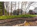 View of this house from across the street with mature trees in the front yard, showcasing landscaping at 764 Sharpshooters Nw Rdg, Marietta, GA 30064