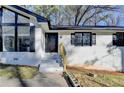 The home features a newly painted white brick exterior and classic black front door at 2773 Marcia Dr, Lawrenceville, GA 30044