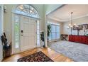 Bright foyer showcasing a hardwood floor entry, a large window and a decorative chandelier at 5106 Vinings Estates Se Way, Mableton, GA 30126