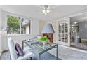 Bright office space featuring a modern glass desk, large windows, and a ceiling fan, offering an ideal work-from-home environment at 80 Montre Nw Sq, Atlanta, GA 30327