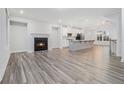Inviting living room with a fireplace, hardwood floors, and an open view into the kitchen area at 139 Jameson E Dr, Acworth, GA 30102