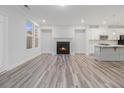 Open-concept living room featuring a fireplace, hardwood floors, recessed lighting, and a view into the kitchen at 139 Jameson E Dr, Acworth, GA 30102
