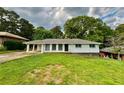 Quaint single-level home boasting a neatly kept lawn, covered carport, and neutral color palette at 4222 Castle Pines Ct, Tucker, GA 30084