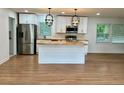 Bright kitchen featuring a butcher block island, stainless steel appliances, and modern pendant lighting at 4222 Castle Pines Ct, Tucker, GA 30084