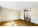 An empty living room with yellow carpet that requires new carpet and paint at 3160 Ann Se Rd, Smyrna, GA 30080