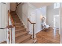 Bright foyer featuring hardwood floors, a carpeted staircase, and access to the home's main living spaces at 4162 Gateswalk Se Dr, Smyrna, GA 30080