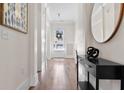 Bright hallway featuring hardwood floors, elegant decor, and natural light from the front door at 4535 Atley Woods Se Dr, Atlanta, GA 30339