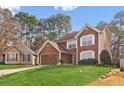 Inviting two-story home featuring a well-kept lawn, brown siding, and an attached garage at 848 Gateshead Ct, Lawrenceville, GA 30043