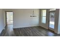 Bright dining area with hardwood floors and modern chandelier. Door to backyard at 204 Saratoga Dr, Acworth, GA 30102