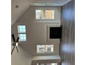 Cozy living room featuring vaulted ceiling, fireplace and modern ceiling fan and hardwood floors at 204 Saratoga Dr, Acworth, GA 30102