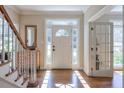 Inviting foyer with hardwood floors, staircase, and natural light streaming through the front door at 4055 River Cliff Chase Se, Marietta, GA 30067
