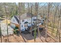 Back of house view showcasing a deck, garage, and mature trees offering privacy at 4055 River Cliff Chase Se, Marietta, GA 30067