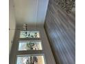 Bright living space features hardwood floors, large windows with lots of natural light, and a modern chandelier at 208 Saratoga Dr, Acworth, GA 30102
