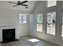 Bright and airy living room with fireplace, vaulted ceiling, large windows and wood floors at 208 Saratoga Dr, Acworth, GA 30102