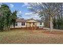Inviting split-level home with a brick facade, cozy front porch, and beautiful mature trees at 2441 Hidden Hills Dr, Marietta, GA 30066