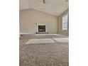 This room showcases high ceilings, a fireplace with a white mantel, and large windows offering natural light at 5550 Mccrossin Cir, Stonecrest, GA 30038