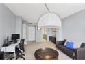 Open-concept living room with comfortable seating, modern lighting, and a versatile layout for various activities at 1280 W Peachtree Nw St # 2613, Atlanta, GA 30309