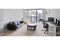 Bright living room featuring a large window with city views, modern furnishings, and a cozy atmosphere at 1280 W Peachtree Nw St # 2613, Atlanta, GA 30309