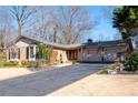 Traditional home featuring a brick facade, manicured lawn and a double garage with an extended driveway at 1341 Longwood Sw Dr, Marietta, GA 30008