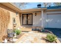 Inviting home entrance featuring a decorative double door, brick walkway and elegant landscaping at 1341 Longwood Sw Dr, Marietta, GA 30008